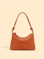 Schicke karamellorange Lederschultertasche mit Knotengurt und silbernen Metallringen - Karamellbraun