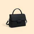 Classic black leather shell bag with lychee grain texture and silver hardware - Black
