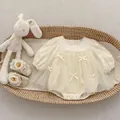 Detail view of cream toddler romper with mesh tutu, bows and matching lace shoes - 66cm / Romper / Cream