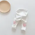 Detail of baby leggings in cream white with soft pink plush heart knee embroidery - 66 / White