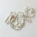 Detailed view of floral long sleeve baby bodysuit set with lace ruffles and matching hat - 100cm / White Floral