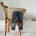Close-up of thick winter baby leggings with plush fleece knee patches in dark grey - 66 / Dark Gray
