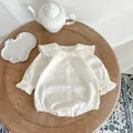 Detail of white long-sleeved baby bodysuit with ruffled Peter Pan collar and buttons - 66CM / White