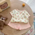 Flat lay of cotton infant summer set with bear print top and checkered shorts - 66cm / Pink Bear