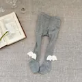 Detailed close-up of grey ribbed baby leggings featuring soft 3D white plush angel wings - S (6-12M) / Gray