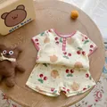 Close-up of cotton infant set featuring cherry and bear prints with plaid trim detailing - 66cm / Cherry