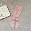Detailed macro view of pink cotton baby tights featuring cute satin bow accents - M (2-4 Years) / Pink