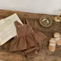 Detail of vintage brown baby cotton set with retro buttons on dark wood background - 66cm / Brown Suspender Romper