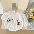 White cotton baby bodysuit with long sleeves and delicate floral embroidery pockets - White / 66cm