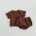 Flat lay of brown striped waffle knit baby summer set with tee and shorts - 66cm / Brown