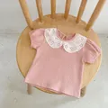 Pink toddler girl short sleeve t-shirt with white eyelet lace collar flat lay on chair - 66 / Pink Top