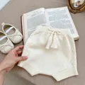 Detail of cream knitted baby bloomers with tassels and matching bow soft-sole shoes - 66CM / Beige Shorts