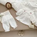 White muslin cotton baby lounge set featuring red cherry embroidery on a ruffled collar - 100cm / White
