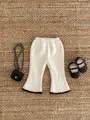 Macro detail of toddler ribbed flared trousers with contrast black serrated edge trim - 66 / Beige Apricot