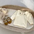 Infant cream long sleeve cotton shirt with floral embroidered Peter Pan collar detail - Embroidered Top (Off-White) / 73cm