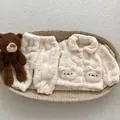 Detail of fleece baby loungewear set with 3D bear pocket in a woven nursery basket - 73cm / Beige Apricot
