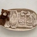 Detail of baby plush pajamas set in a woven basket showing soft coral fleece texture - 73cm / Light Khaki