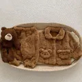 Detailed close-up of baby teddy fleece pajamas set with cute bear pockets in a basket - 73cm / Brown