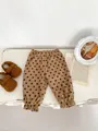Brown polka dot corduroy pants for kids with elastic waist and ruffled hem details - 120cm / Brown
