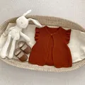 Infant rust red knit vest with ruffle sleeves and matching leather shoes in a basket - Brown / 100cm
