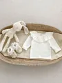 Flat lay of white baby long sleeve top with lace collar and toy in a wicker basket - 66cm / Pure White Single Edge