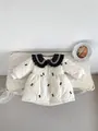 Quilted toddler winter coat in cream with black bow embroidery and ruffled collar - White / 66cm