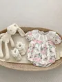 Floral baby bodysuit with lace trim and matching shoes in a woven bassinet - 66cm / Baby Romper
