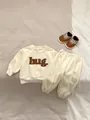 Infant long sleeve tracksuit set in cream with 3D hug embroidery and matching joggers - Set / 73cm / Apricot