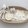 Flat lay of baby girl floral embroidery cotton top and shorts set in a basket - 66 / Off-White Embroidered