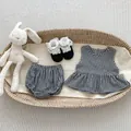 Flat lay of baby girl gingham sleeveless top and bloomer set with plush bunny - 66 / Black White Grid