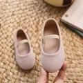 Pink Mary Jane flat shoes for girls with elastic strap shown on a soft textured background - Beige