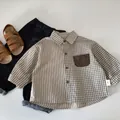 Flat lay of boy shirt with contrast patchwork stripes and plaids with navy jeans - 90cm / Brown