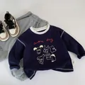 Detailed flat lay of navy blue long sleeve toddler T-shirt with cute dog print and grey pants - 120cm