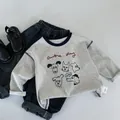 Detailed flat lay of children's grey long sleeve tee with dog prints and denim jeans - 120cm