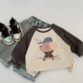 Flat lay of kids' raglan sleeve t-shirt with cute dog print and denim jeans outfit - 90cm / Apricot And Gray