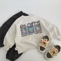 Flat lay of a grey puppy sweatshirt, striped pants and green sneakers for toddlers - Off-White Grey / 90cm