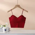 Minimalist deep red V-neck camisole with thin straps and built-in pads on wooden hanger - S / Burgundy