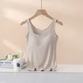 Sleeveless beige rib-knit camisole with built-in chest pads shown hanging on a hanger - S / Beige