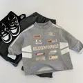 Flat lay detail of kids three-piece casual sports set with printed hoodie and joggers - 90cm / Heather Grey