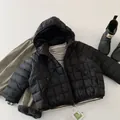 Flat lay of kids waterproof black quilted down jacket with Teflon functional hangtag - Black / 90cm