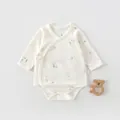 Detail of newborn cotton bodysuit with delicate duck print and side-tie bow closure - Goose Print Style