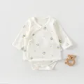 Detail of newborn cotton bodysuit featuring side ties and fresh green plant patterns - Potted Flower Style