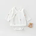 Detail of newborn cotton bodysuit featuring side ties and sun print on white fabric - 52 / Little Sun