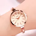 Elegant rose gold women's watch with minimalist round dial and thin bangle strap on wrist - IP Rose Gold Case Rose Gold Dial