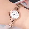 Fashionable rose gold women's watch with white dial and blue hands worn on wrist - Rose Gold White Dial