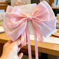 Elegant large pink pearlescent ribbon bow hairclip for girls with long flowing streamers - Satin Bow With Ribbon / Pink