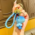 Charming blue resin dinosaur keychain featuring a matching braided blue wrist strap - Gradient Knit Dinosaur-Blue
