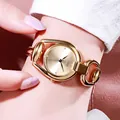 Elegant gold bracelet watch for women featuring a minimalist round dial and horseshoe links - Gold Case Gold Dial