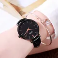 GEDI women's black leather watch set with a rose gold heart bracelet on wrist - Night Black