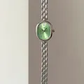 Detail of vintage oval green dial watch with Roman numerals and silver link bracelet - Silver Case Green Dial